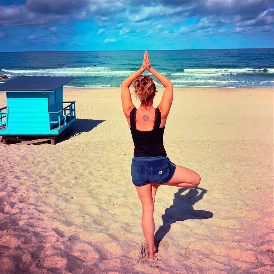 Posture de l'arbre sur le sable, face à l'océan